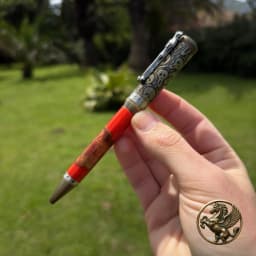 Antique Bronze Spooky Twist Pen with an example wood and red resin barrel